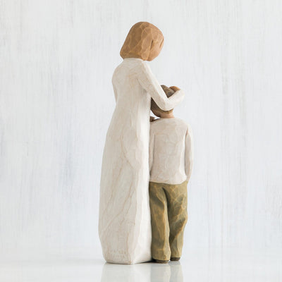 Mother and Son, Willow Tree, with standing figure in cream dress, with arms around young boy in cream shirt and dark pants.