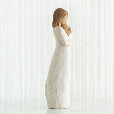 Angel of Mine - Willow Tree with in a cream dress, holding an infant in a cream blanket to her chest