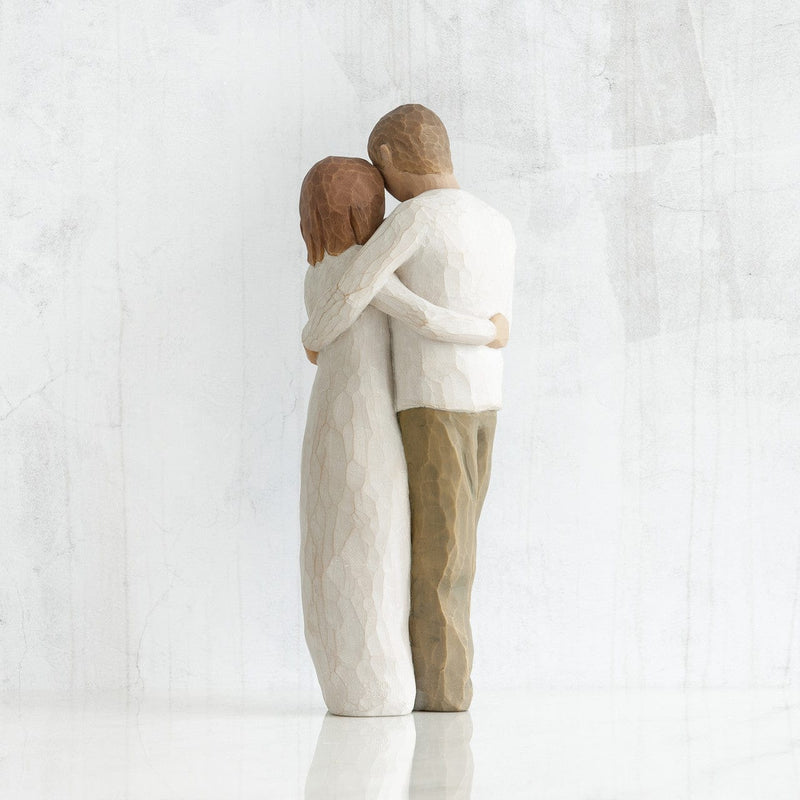 Our Gift: A Willow Tree with a standing couple holding a baby between them. in a cream onesie, dress, shirt, and dark jeans