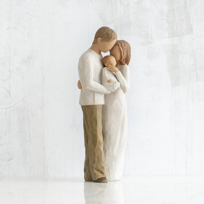 Our Gift: A Willow Tree with a standing couple holding a baby between them. in a cream onesie, dress, shirt, and dark jeans