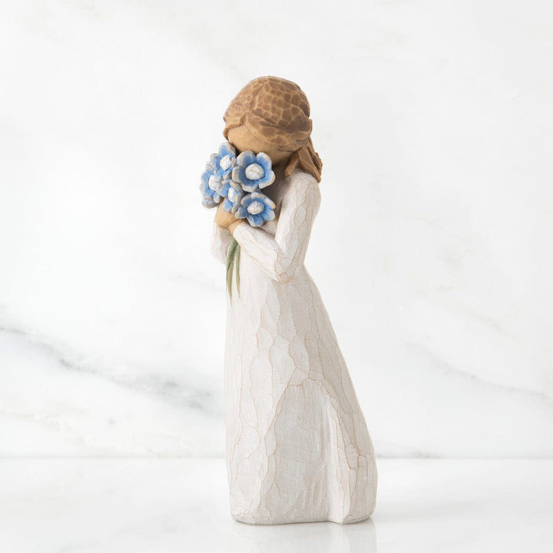Forget-me-not: Willow Tree in a cream dress, holding a large bouquet of blue forget-me-not flowers up to her face.