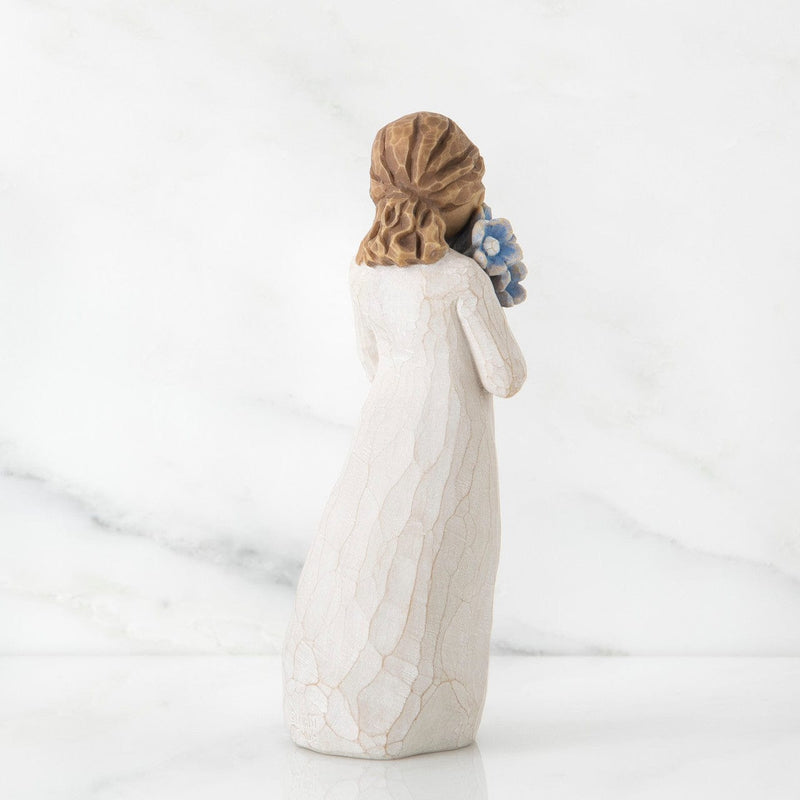 Forget-me-not: Willow Tree in a cream dress, holding a large bouquet of blue forget-me-not flowers up to her face.