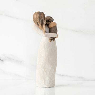 Adorable You (Dark Dog) – Willow Tree with standing figure in a cream dress, holding the dark-colored puppy in her arms