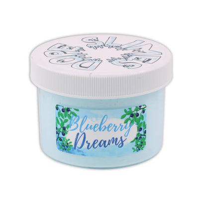 Container of Blueberry Dreams slime by Dope Slimes. Light blue slime with a fake blueberry on top