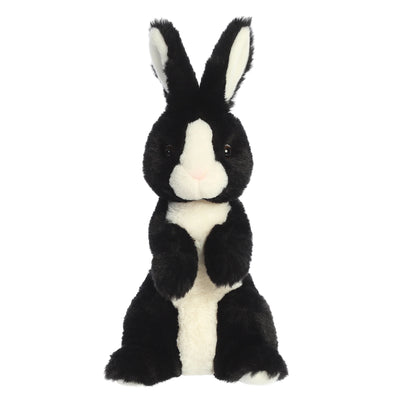 Black and white plush rabbit with floppy ears and stitched smile.