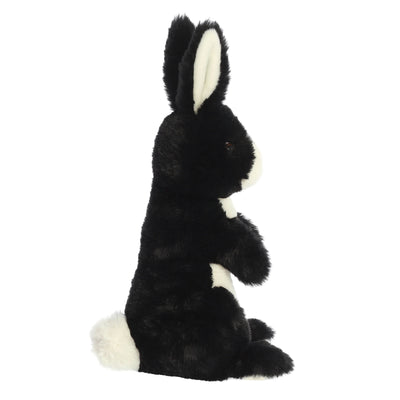 Black and white plush rabbit with floppy ears and stitched smile.