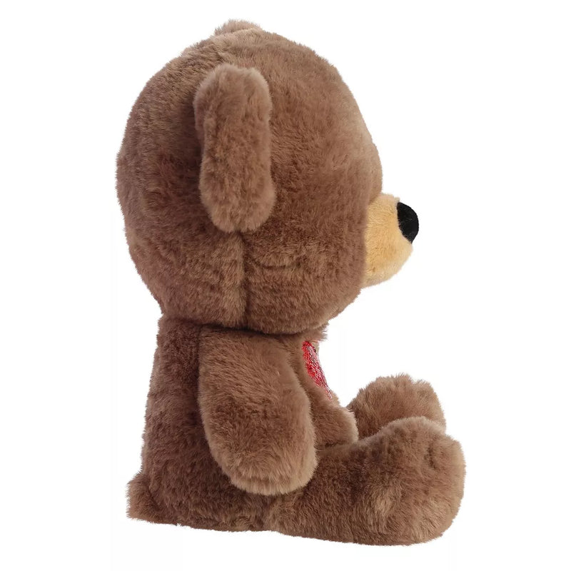 brown teddy bear with a red sequined heart sewn on its chest