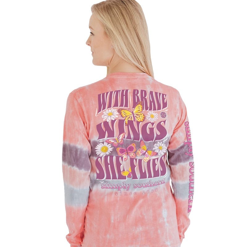 With brave wings, she flies long sleeves with orange, purple, and gray tie-dye stripes, daisies, and butterflies.