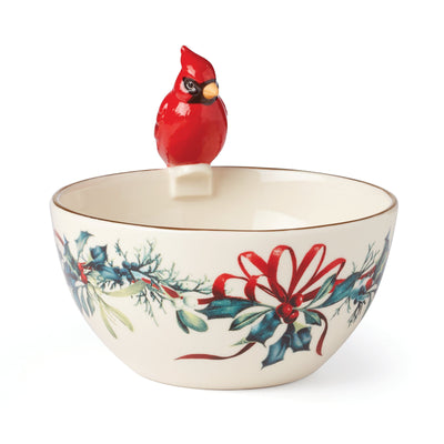 This bowl is made of porcelain and features an embossed design of a cardinal and holly branches.