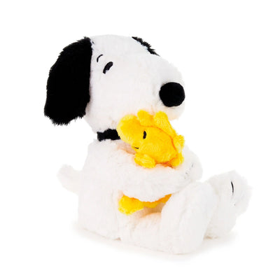 Snoopy and Woodstock are hugging.