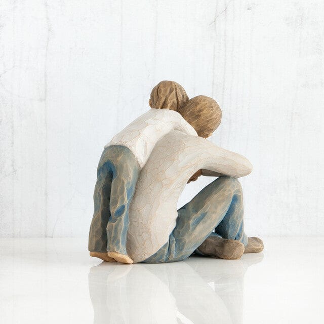 Willow Tree line of sculptures created by Susan Lordi. It depicts a father and son embracing