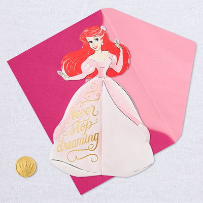 A pop-up greeting card features an intricate laser-cut design of Disney Princess Ariel from