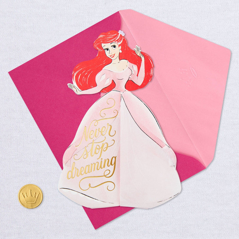 A pop-up greeting card features an intricate laser-cut design of Disney Princess Ariel from