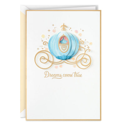 Blank greeting card features a layered, dimensional attachment of Cinderella's carriage with gold foil
