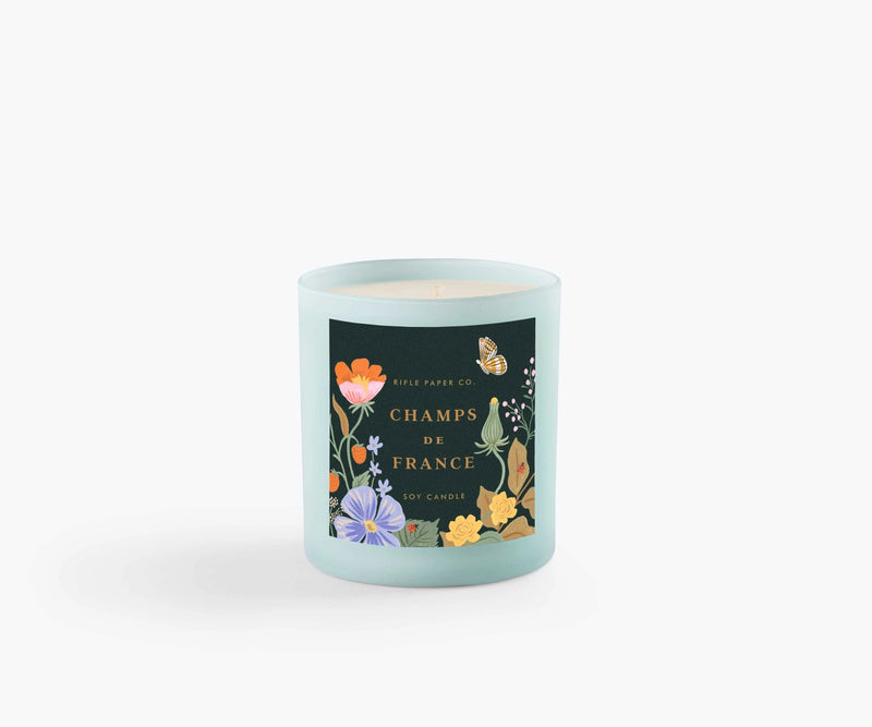 The 9.5-ounce soy wax candle comes in a painted glass vessel and is packaged in a decorative gift box with gold foil accents.