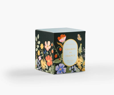 The 9.5-ounce soy wax candle comes in a painted glass vessel and is packaged in a decorative gift box with gold foil accents.