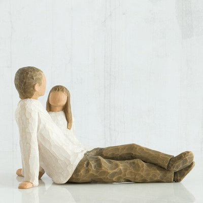 Willow Tree's New Dad figurine is a timeless sculpture capturing the awe and wonder of a new father holding his baby.