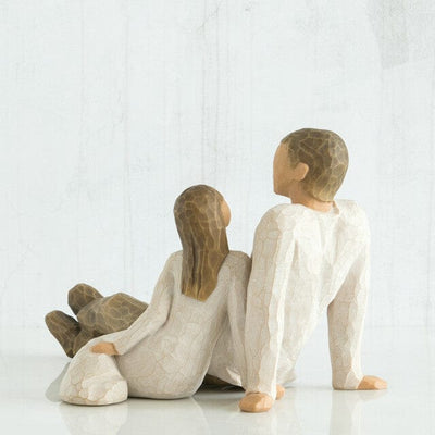 Willow Tree's New Dad figurine is a timeless sculpture capturing the awe and wonder of a new father holding his baby.