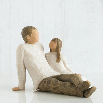 Willow Tree's New Dad figurine is a timeless sculpture capturing the awe and wonder of a new father holding his baby.