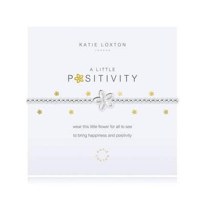 features a rose gold wine glass charm and is presented on a branded card with the "a little positives" title in rose gold.