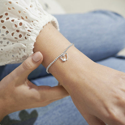 Boxed bracelet with gold-embossed 'Happy Mother's Day' sentiment and silver charm inside.

