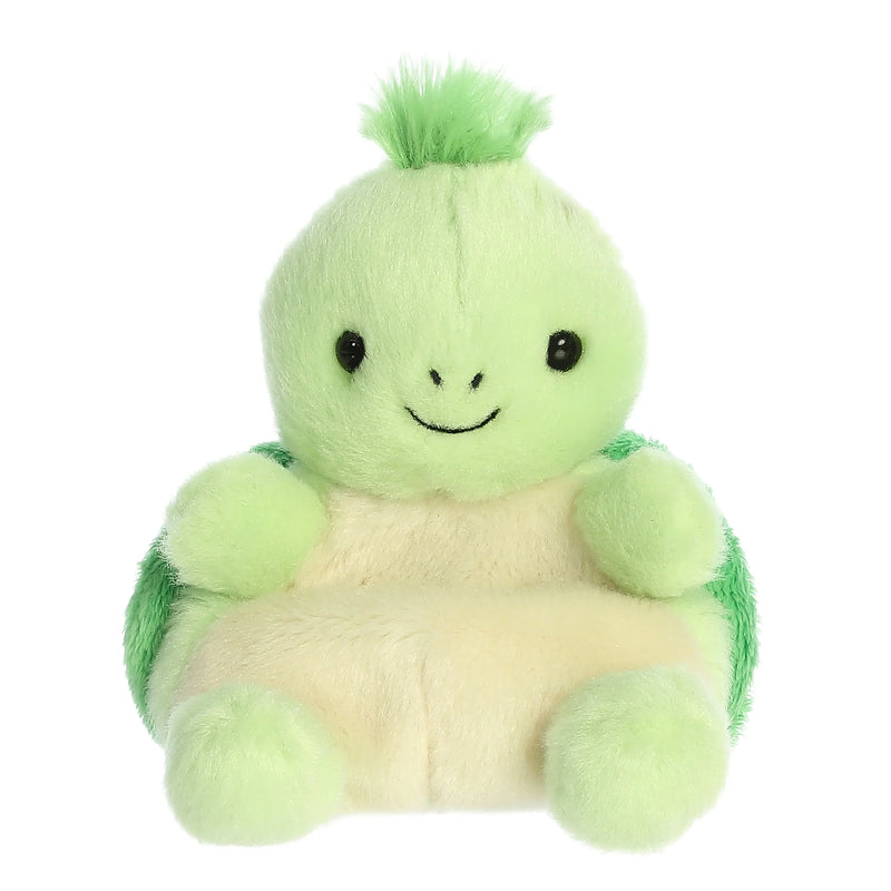 Small green plush turtle sitting in plaid armchair.